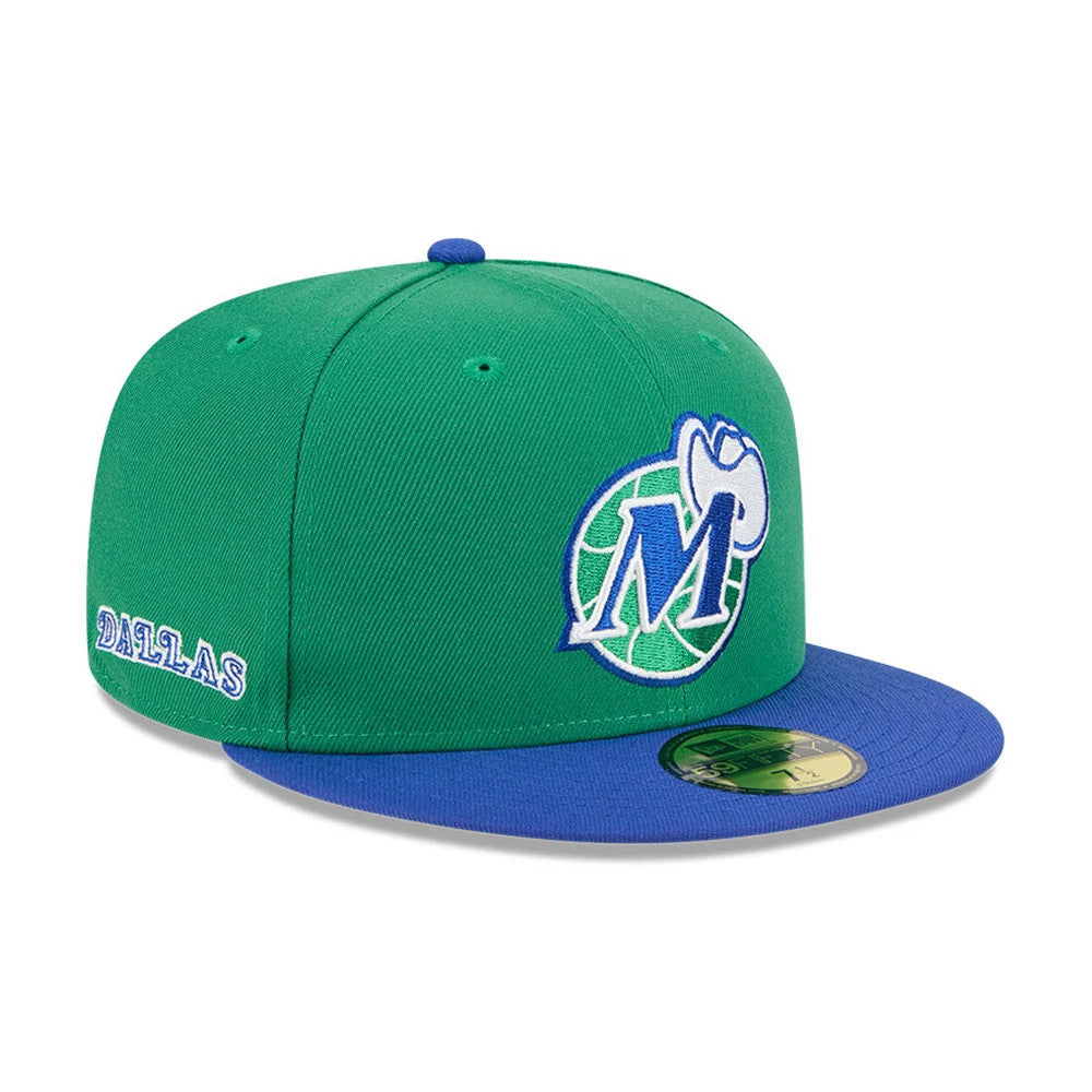 Dallas Mavericks NBA Classic Green New Era 59FIFTY Fitted Cap, three-quarter view showing the blue and white Mavericks logo embroidered on the front panel, with a blue visor and a gold 59FIFTY size sticker.