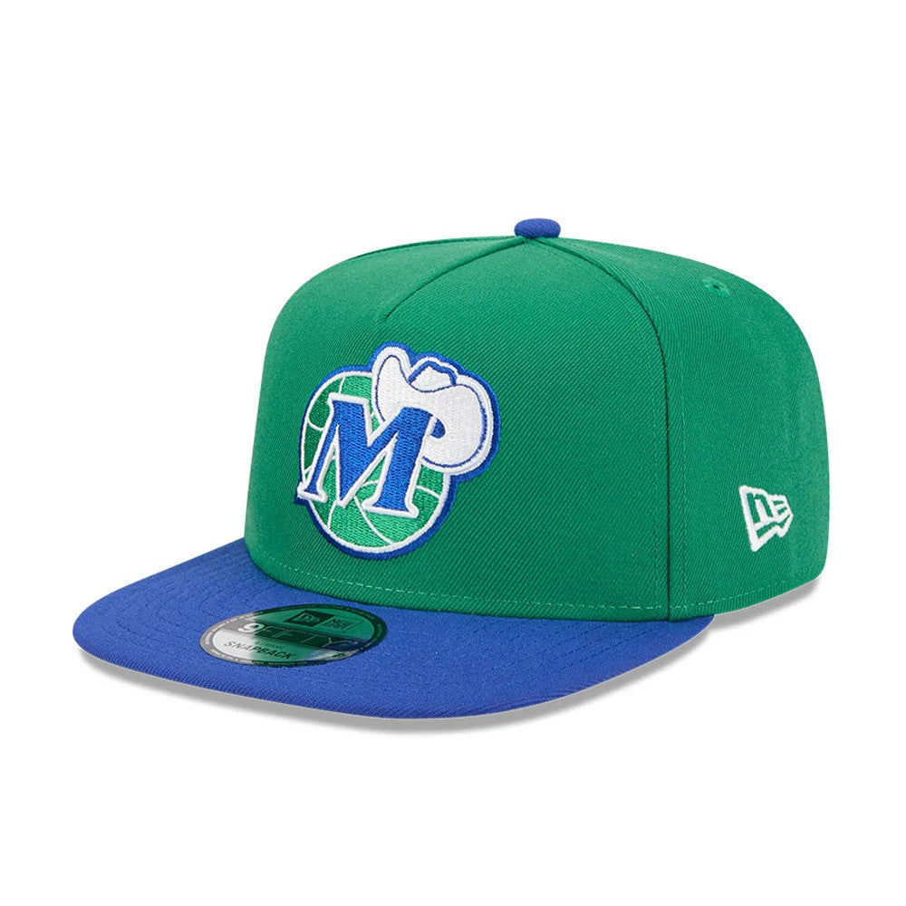 Dallas Mavericks NBA Classic Green New Era 9FIFTY A-Frame Snapback Adjustable Cap, three-quarter view showing the blue and white team logo embroidered on the front panel, with a flat blue visor and New Era flag logo on the left side.