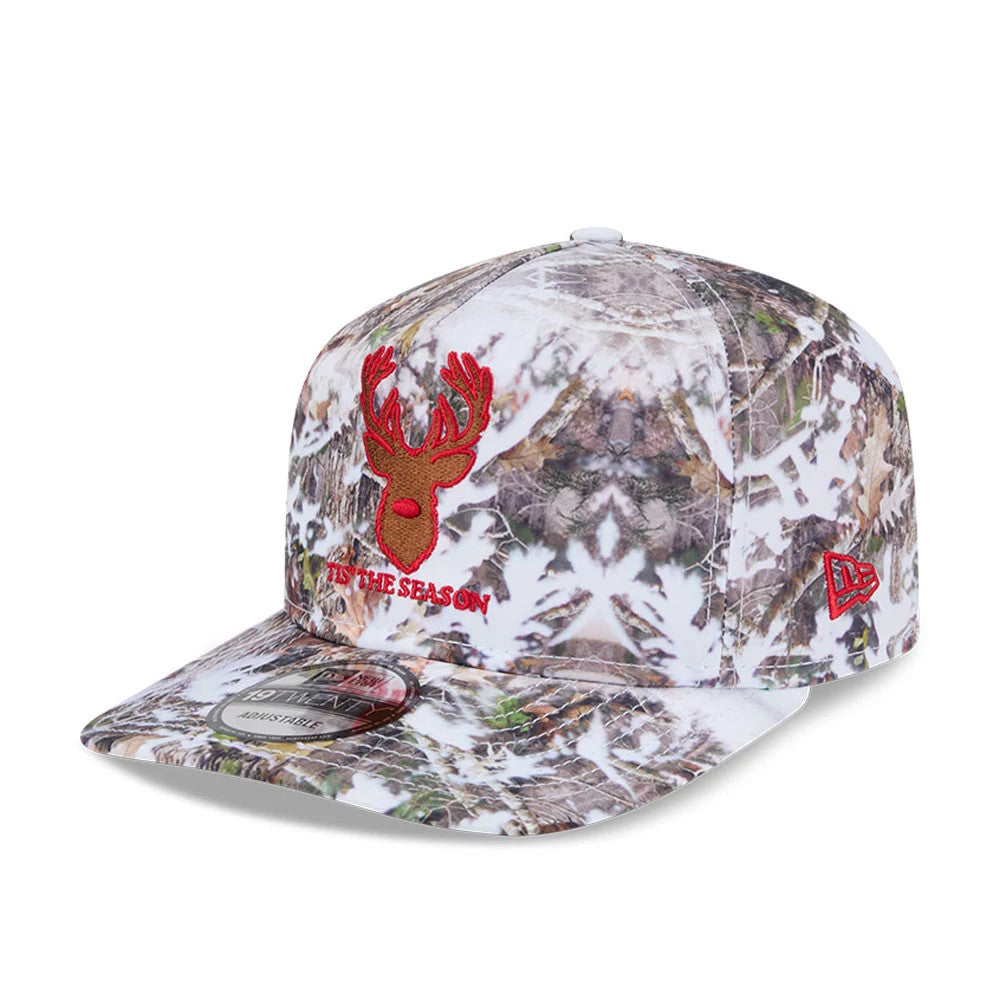 New Era Holiday Essentials Photoreal 19TWENTY Adjustable Cap, three-quarter view showing a red embroidered reindeer head and 'Tis the Season text on the front panel, with a photoreal camouflage print and red New Era flag logo on the left side.