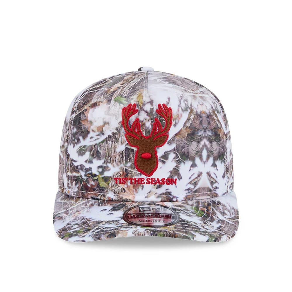New Era Holiday Essentials Photoreal 19TWENTY Adjustable Cap, front view showing a red embroidered deer head and 'Tis The Season lettering on the photoreal tree pattern, with a 19TWENTY size sticker on the curved visor.