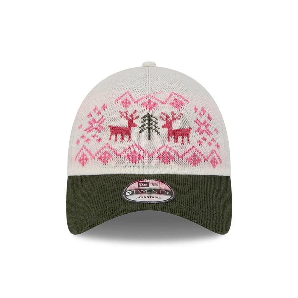 New Era Holiday Essentials White 9TWENTY Adjustable Cap, front view featuring a pink and red festive pattern with reindeer and tree on the white crown, complemented by a dark green curved visor and a 9TWENTY size sticker.