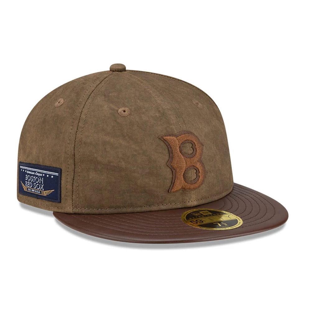 Boston Red Sox MLB Open Brown Retro Crown New Era 59FIFTY Fitted Cap, three-quarter view showing a brown embroidered B on the front panel, brown flat visor with gold 59FIFTY size sticker, and a team logo patch on the left side.