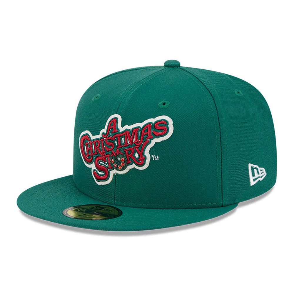 A Christmas Story Warner Brothers Green New Era 59FIFTY Fitted Cap, three-quarter view showing the raised red and white embroidered logo on the front panel, flat green visor with gold 59FIFTY size sticker.