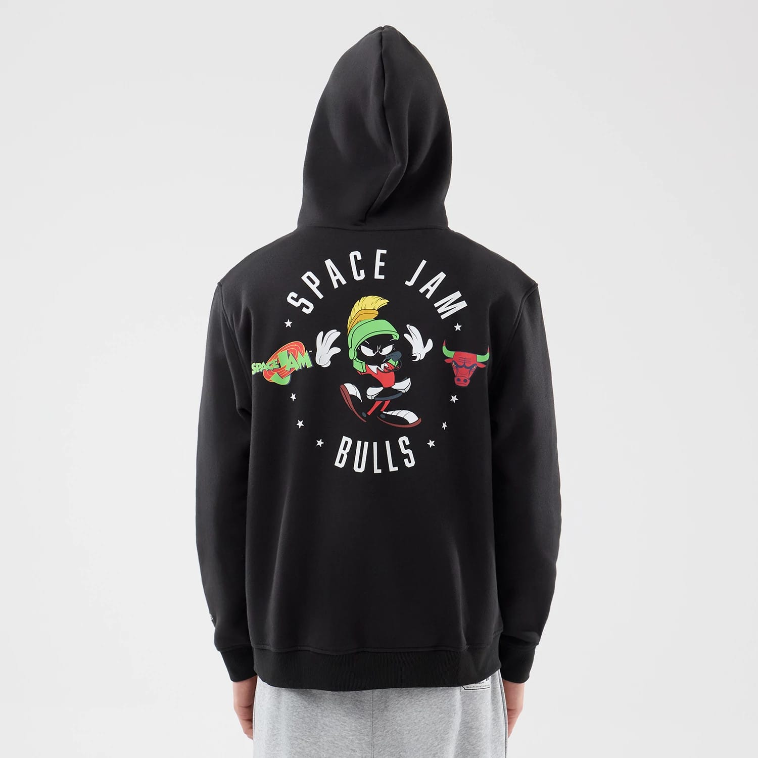 New Era Chicago Bulls Space Jam 2 X NBA Black Pullover Hoodie, back view on a model displaying a graphic of Marvin the Martian between Space Jam and Bulls lettering with small stars across the upper back.