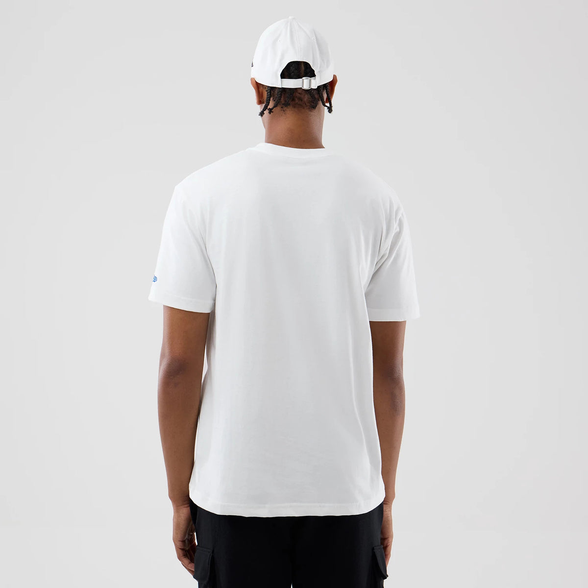 New Era Chicago Bulls Space Jam 2 X NBA White T-Shirt, back view on a model wearing a cap, showing a plain white back and short sleeves with a small printed logo on the left sleeve.