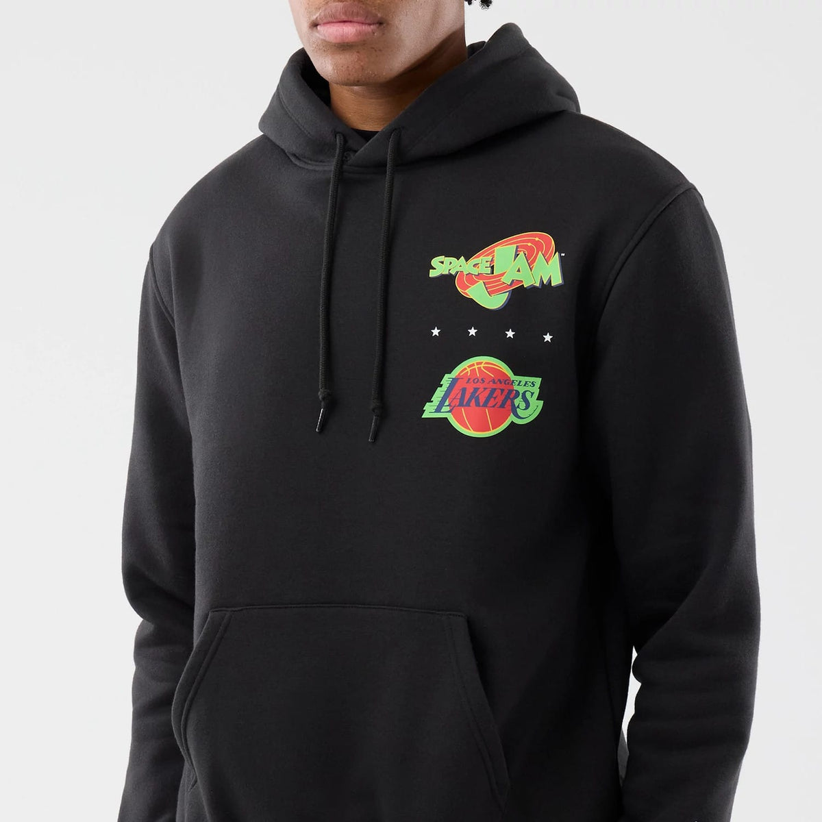 New Era LA Lakers Space Jam 2 X NBA Black Pullover Hoodie, front view on a model showing the green and red Space Jam logo above the Los Angeles Lakers logo on the chest with a pocket below and black drawstrings on the hood.