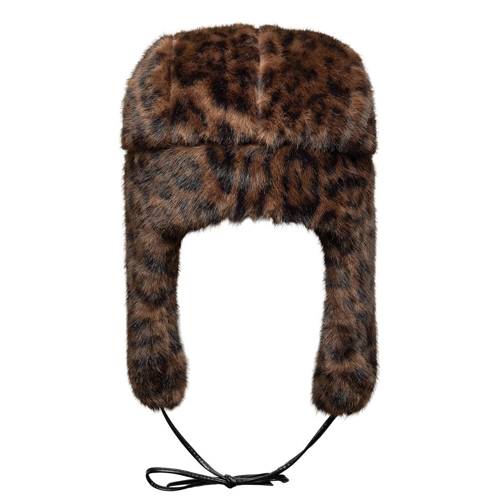 New Era Leopard Brown Trapper Hat, front view showing the rich brown and black leopard pattern covering the entire hat, with long ear flaps hanging down each side and black adjustable chin cords tied below.