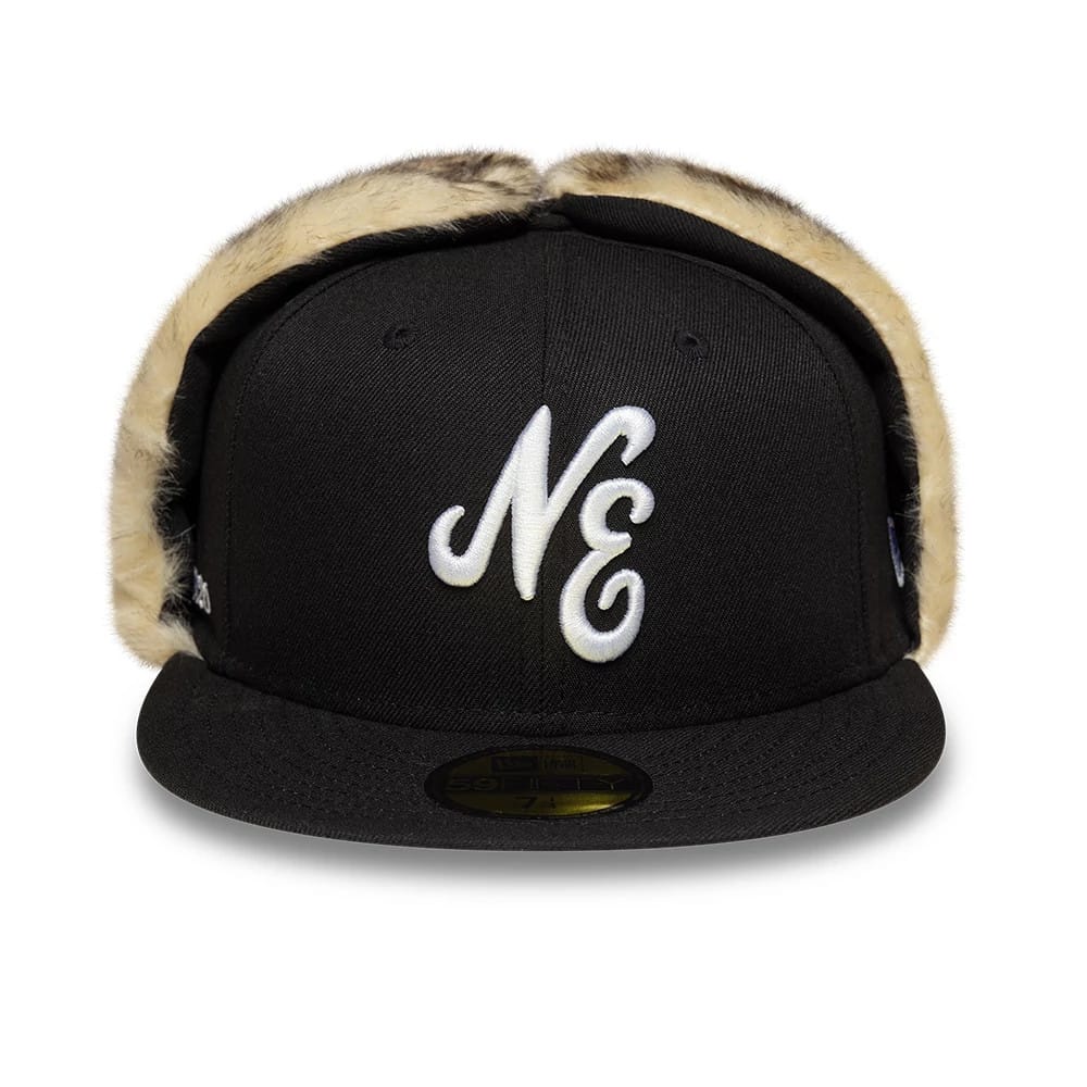 New Era Black Dogear 59FIFTY Fitted Cap, front view showing white NE script embroidery on the black structured crown, with furry side panels and a flat black visor with a gold 59FIFTY size sticker.