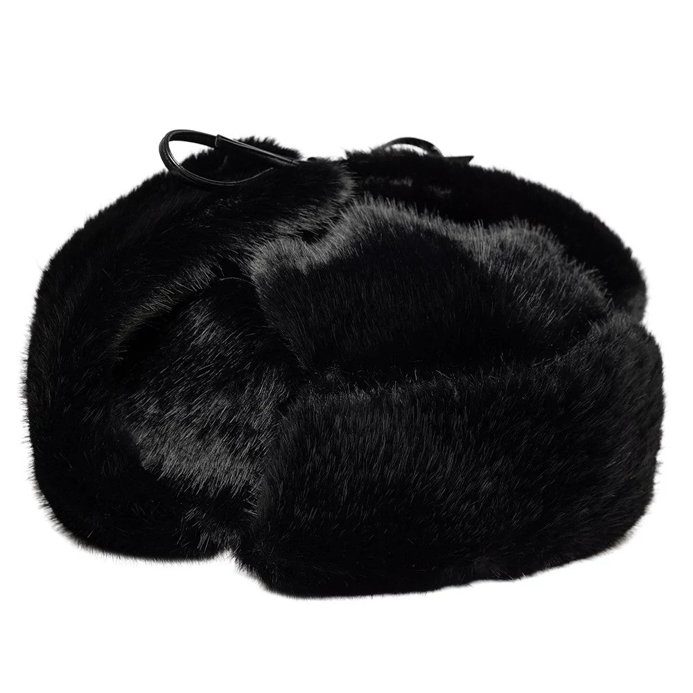 New Era Faux Fur Black Trapper Hat, side view showing the plush black faux fur texture with adjustable chin straps at the top and ear flaps folded up to display the luxurious material and construction.