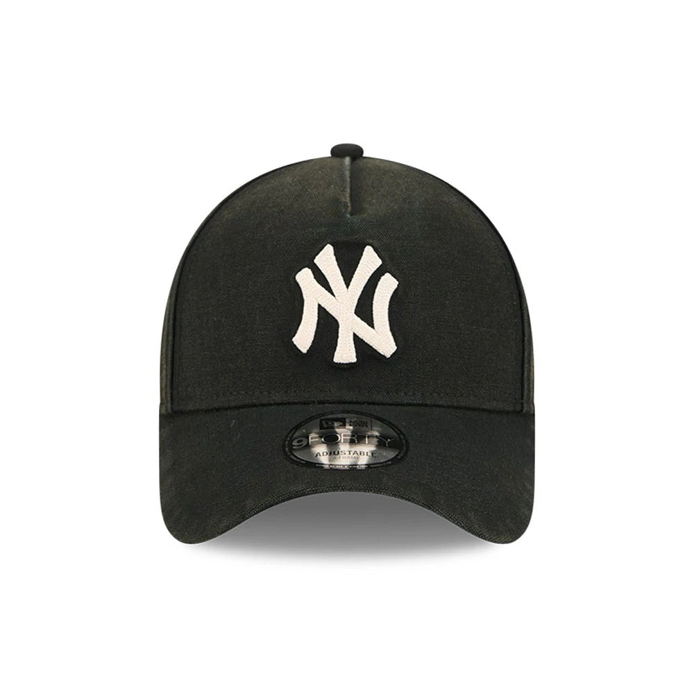 New York Yankees MLB Washed Canvas Black New Era 9FORTY A-Frame Adjustable Cap, front view showing the raised white embroidered NY logo on the structured black crown and a 9FORTY size sticker centred on the curved visor.
