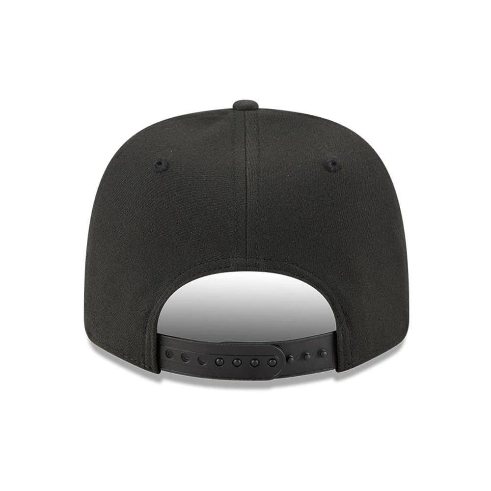 New Era Flawless Black 9SEVENTY Stretch Snap Adjustable Cap, rear view showing the black embroidered logo at the centre of the back panels with a black adjustable snap closure and streamlined black eyelets on the structured crown.