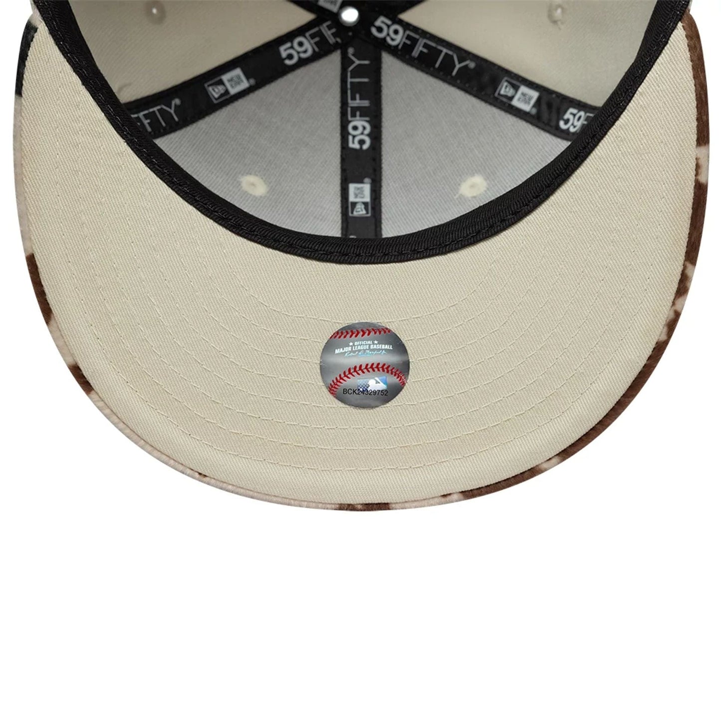 New York Yankees Animal Print Beige New Era 59FIFTY Fitted Cap, inside view showing the cream undervisor with a baseball sticker, black taping with white 59FIFTY lettering, and contrasting animal print details on the visor edge.