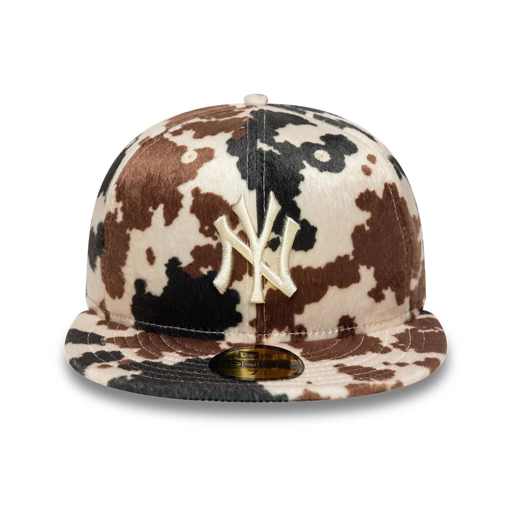 New York Yankees Animal Print Cow Beige New Era 59FIFTY Fitted Cap, front view showing the raised beige NY logo in embroidery on the cow pattern crown and the gold 59FIFTY size sticker on the flat beige visor.
