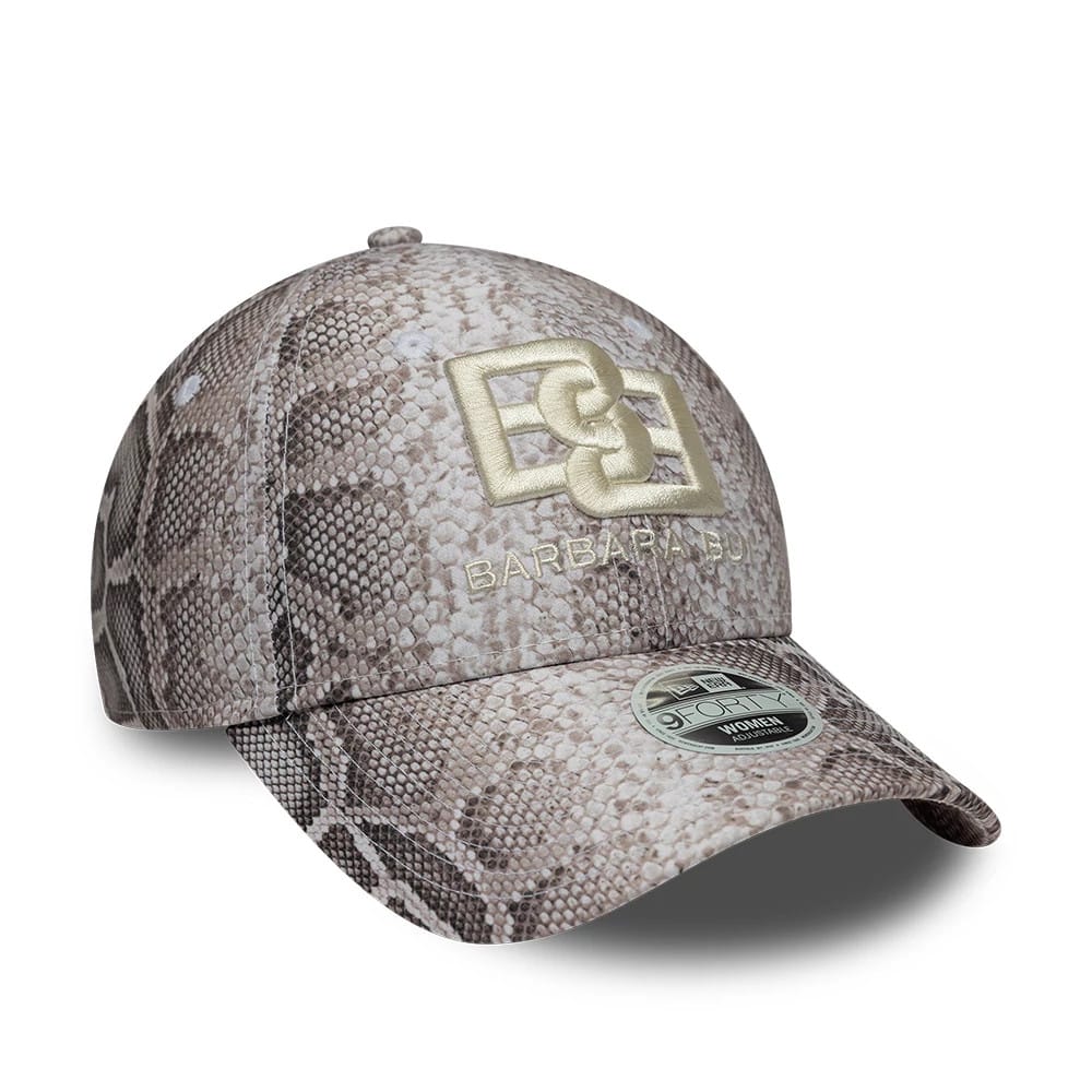 Womens New Era X Barbara Bui Python All Over Print 9FORTY Adjustable Cap, three-quarter view showing the gold embroidered logo on the front panel with a matching size sticker on the curved python print visor.