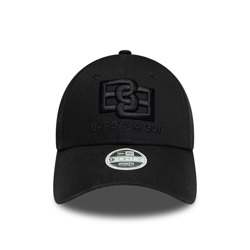 Womens New Era X Barbara Bui Core Black 9FORTY Adjustable Cap, front view showing raised black embroidered logo on the front panel with black BARBARA BUI lettering beneath, and 9FORTY size sticker on the curved black visor.
