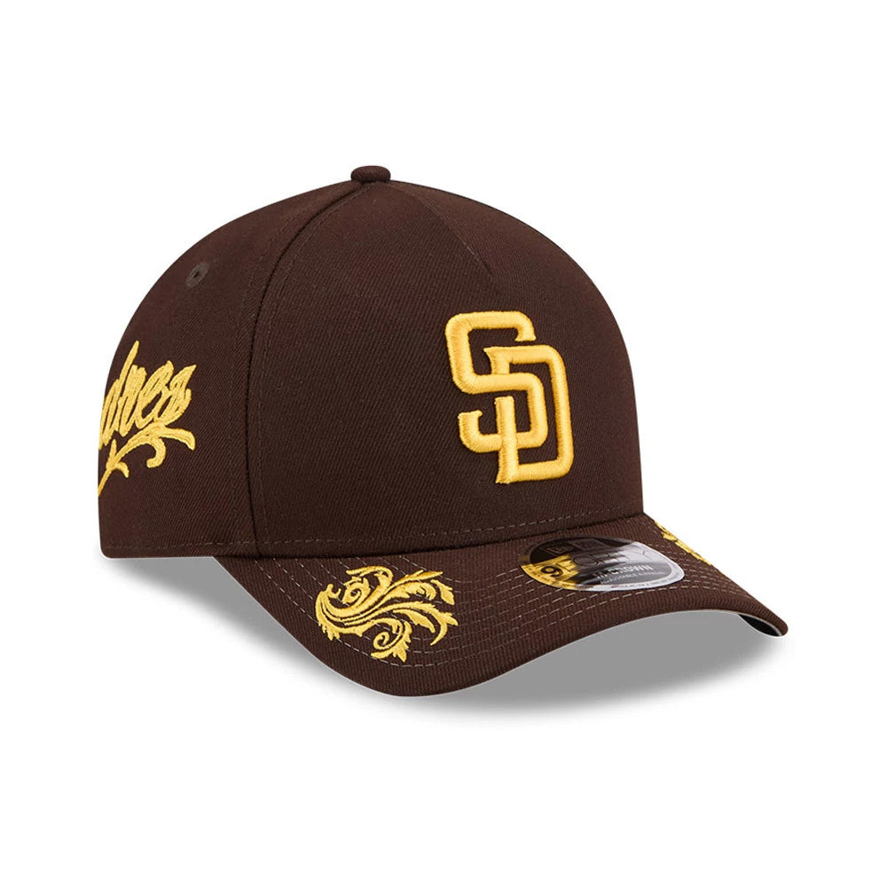 San Diego Padres MLB Script Dark Brown New Era 9FORTY M-Crown A-Frame Adjustable Cap, three-quarter view showing the yellow embroidered SD logo on the front panel, intricate yellow patterns beneath the visor, and Padres script on the side.