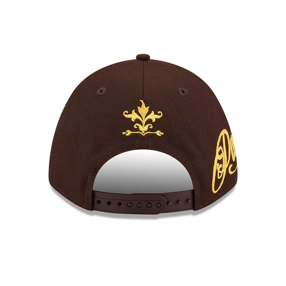 San Diego Padres MLB Script Dark Brown New Era 9FORTY M-Crown A-Frame Adjustable Cap, rear view showing a gold embroidered fleur-de-lis above the brown adjustable strap, with part of the script logo on the side panel.