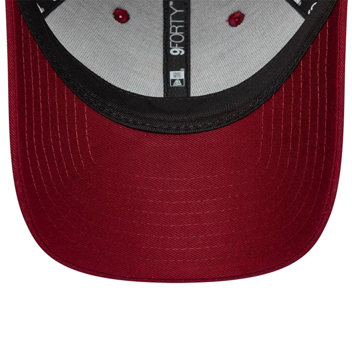 FC Barcelona Core Dark Red New Era 9FORTY Adjustable Cap, inside view showing the grey sweatband and taping with 9FORTY branding, and contrasting black undervisor with red eyelet accents on the crown.