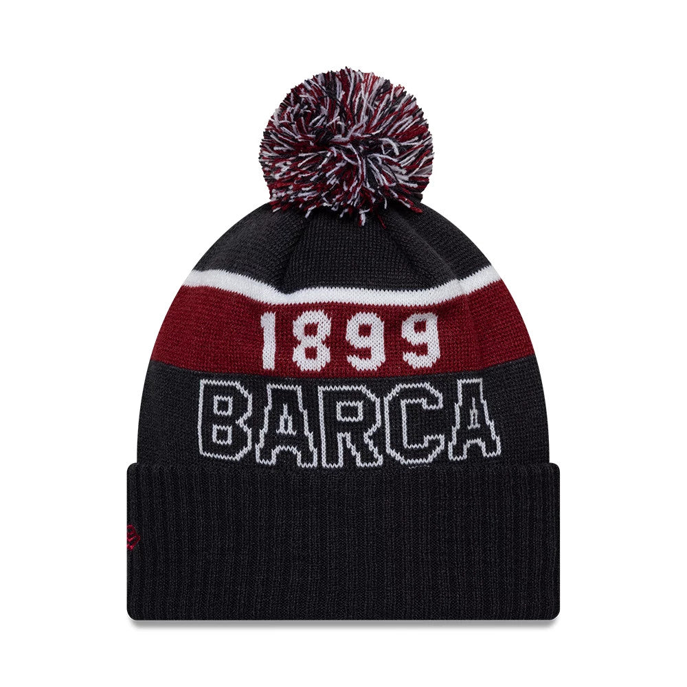 New Era FC Barcelona Core Navy Sport knit Beanie Hat, front view showing the 1899 text in white on a red and white stripe above a large BARCA lettering in white on the navy cuff, topped with a multicoloured pom-pom.