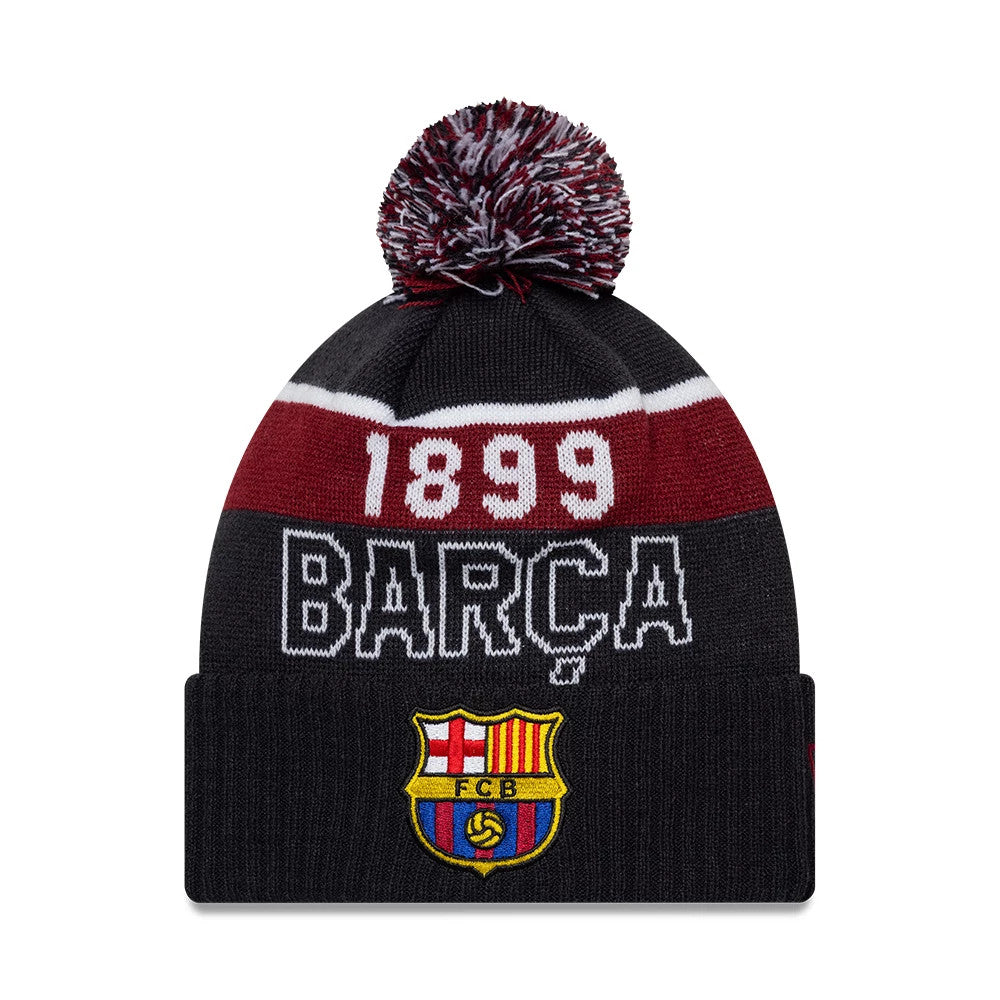 New Era FC Barcelona Core Navy Sport knit Beanie Hat, front view showing a red and white 1899 and BARÇA text pattern below a navy and white pom-pom, with the FC Barcelona crest embroidered on the folded cuff.