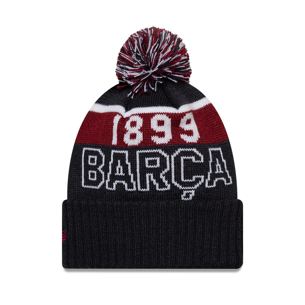 New Era FC Barcelona Youth Core Navy Sport knit Beanie Hat, front view showing large white '1899' and 'BARÇA' lettering on the front panel, with a red, white, and navy pom-pom on top and New Era flag logo on the cuff.