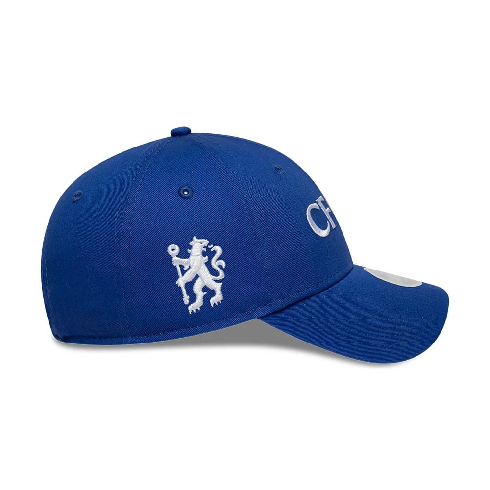 Chelsea FC Womens Core Blue New Era 9FORTY Cap, side view showing the white embroidered lion logo on the left panel and CFC lettering embroidered in white on the front, with a curved blue visor and 9FORTY size sticker.