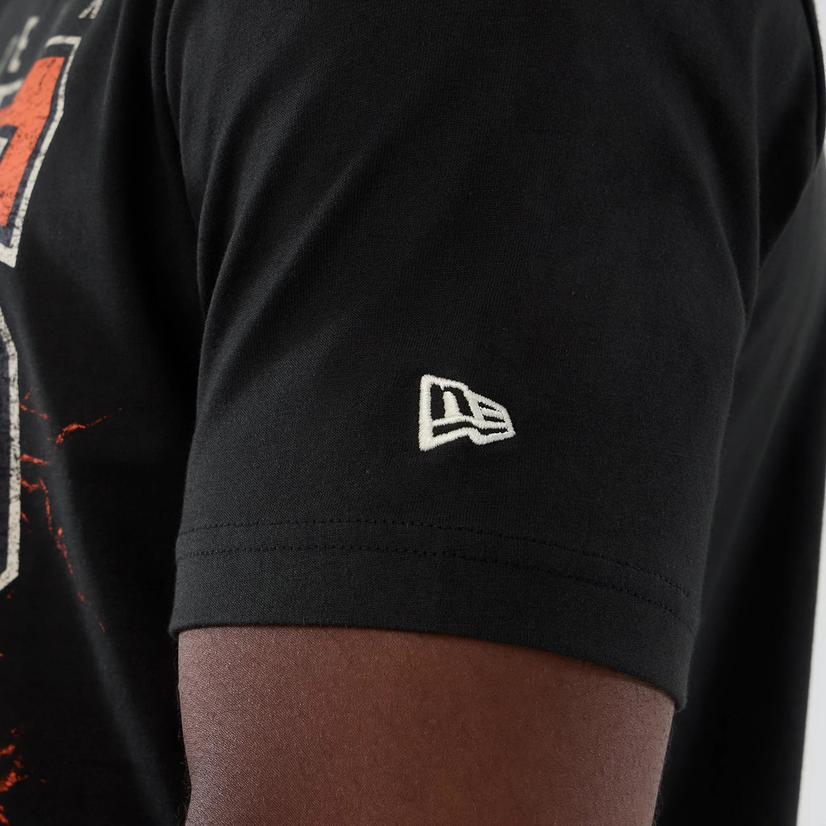 New Era Phoenix Suns NBA Hardwood Classic Black T-Shirt, side view close-up showing the small white embroidered New Era logo on the sleeve, with part of a graphic design on the body.