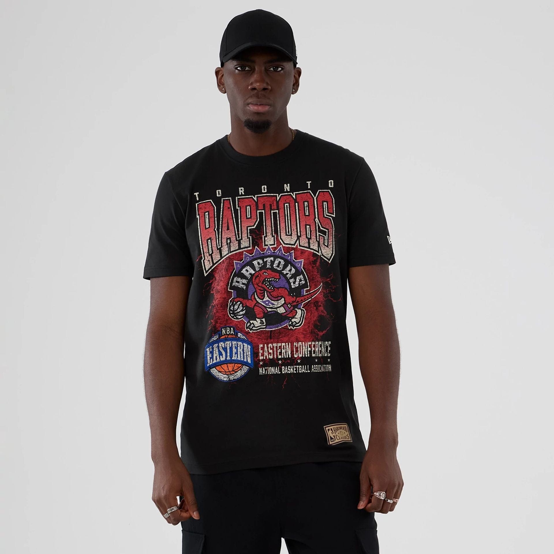 The model is wearing this NBA Hardwood Classic Toronto Raptors T-Shirt in black. 1
