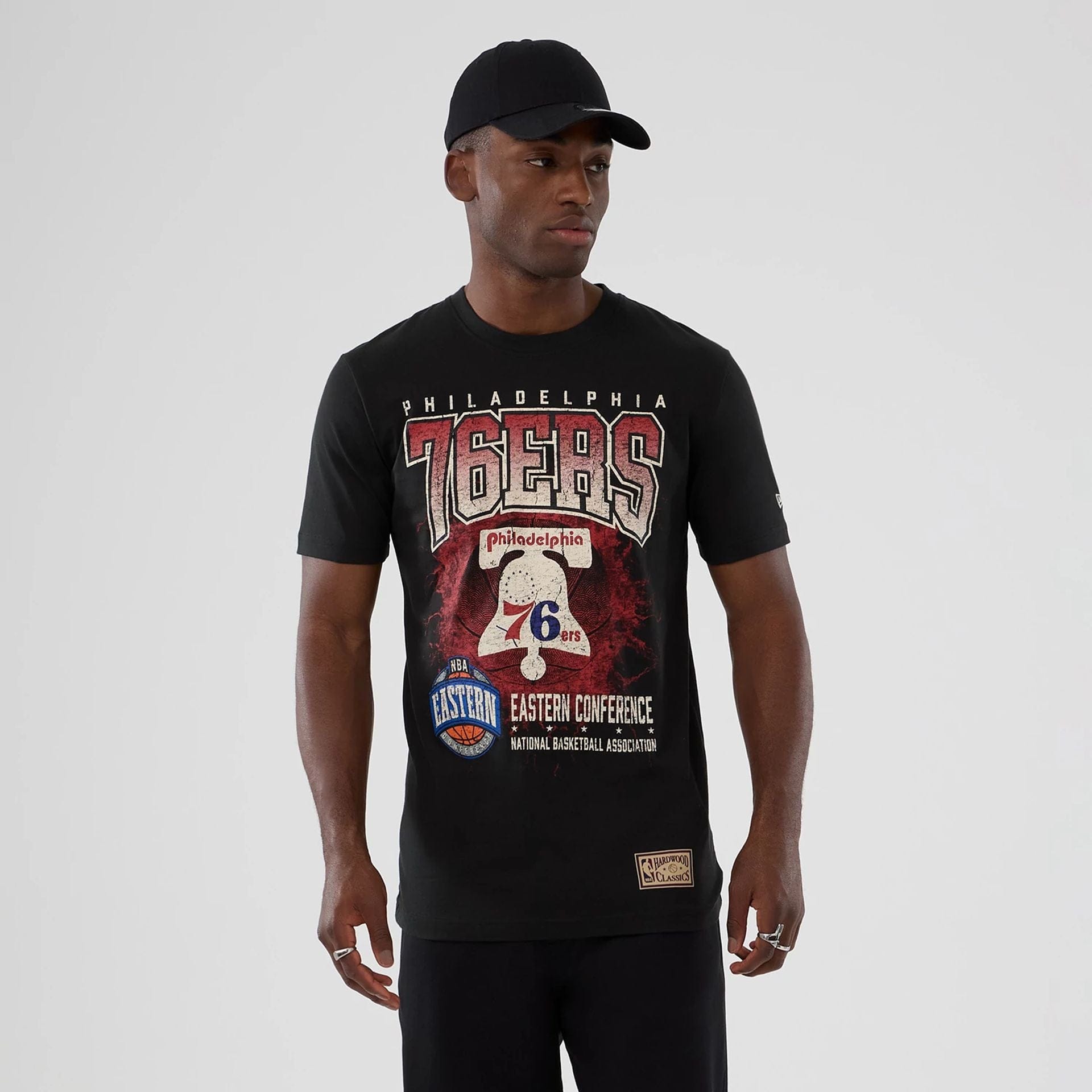 The model is wearing this NBA Hardwood Classic Philadelphia 76ers T-Shirt in black. 1
