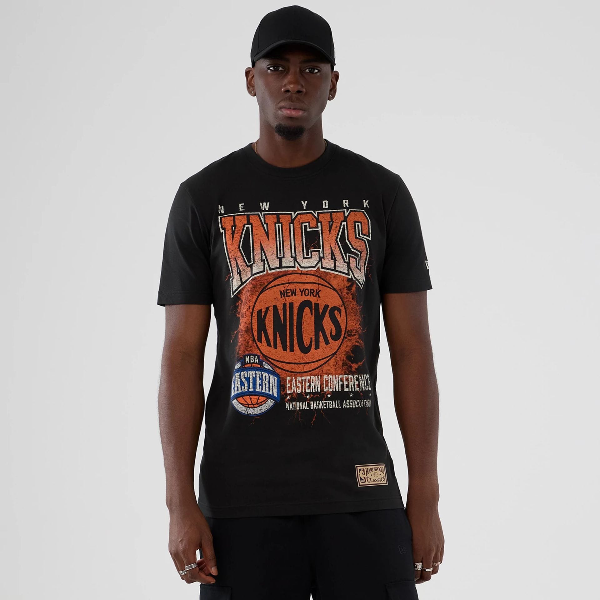 The model is wearing this NBA Hardwood Classic New York Knicks T-Shirt in black. 1