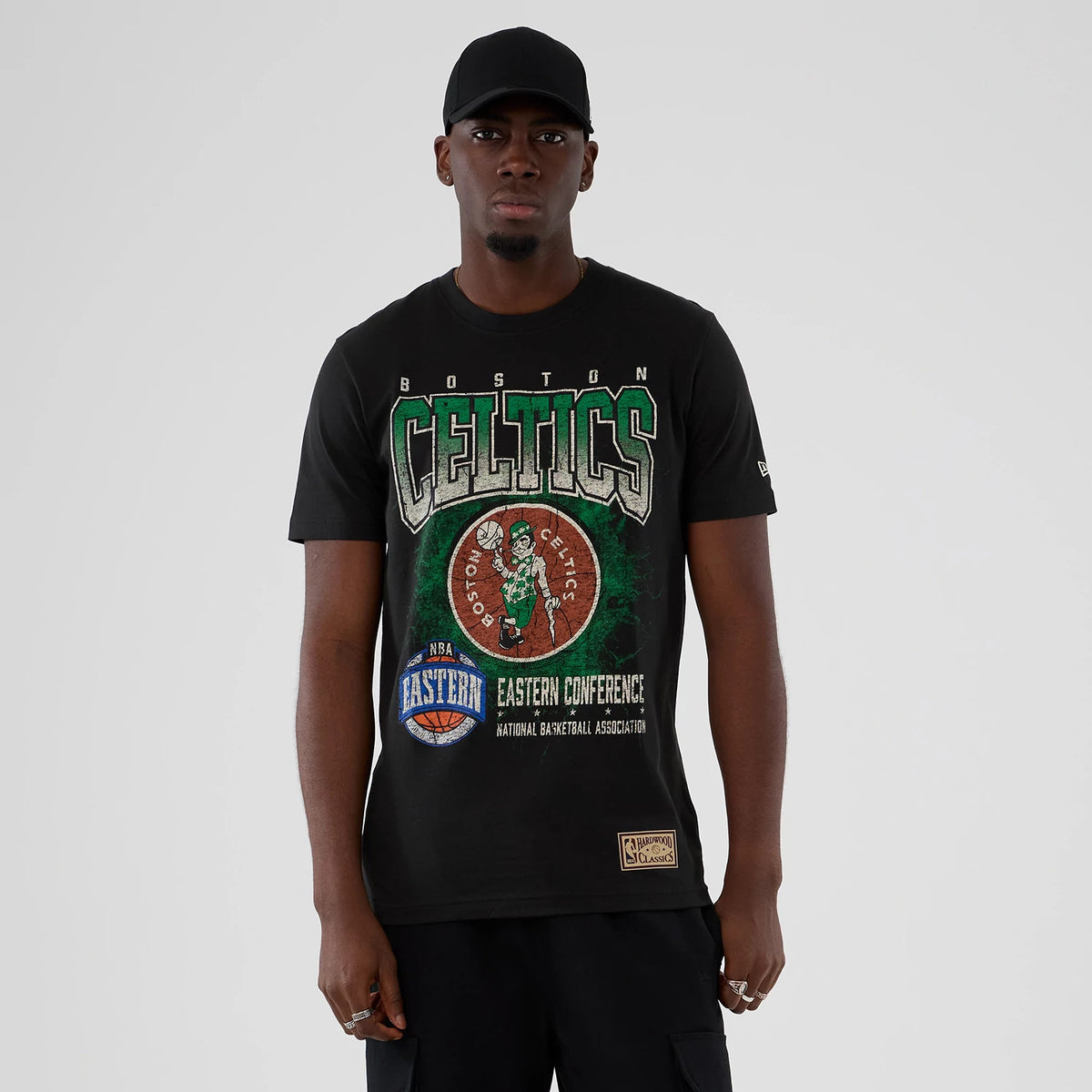 The model is wearing this NBA Hardwood Classic Boston Celtics T-Shirt in black. 1