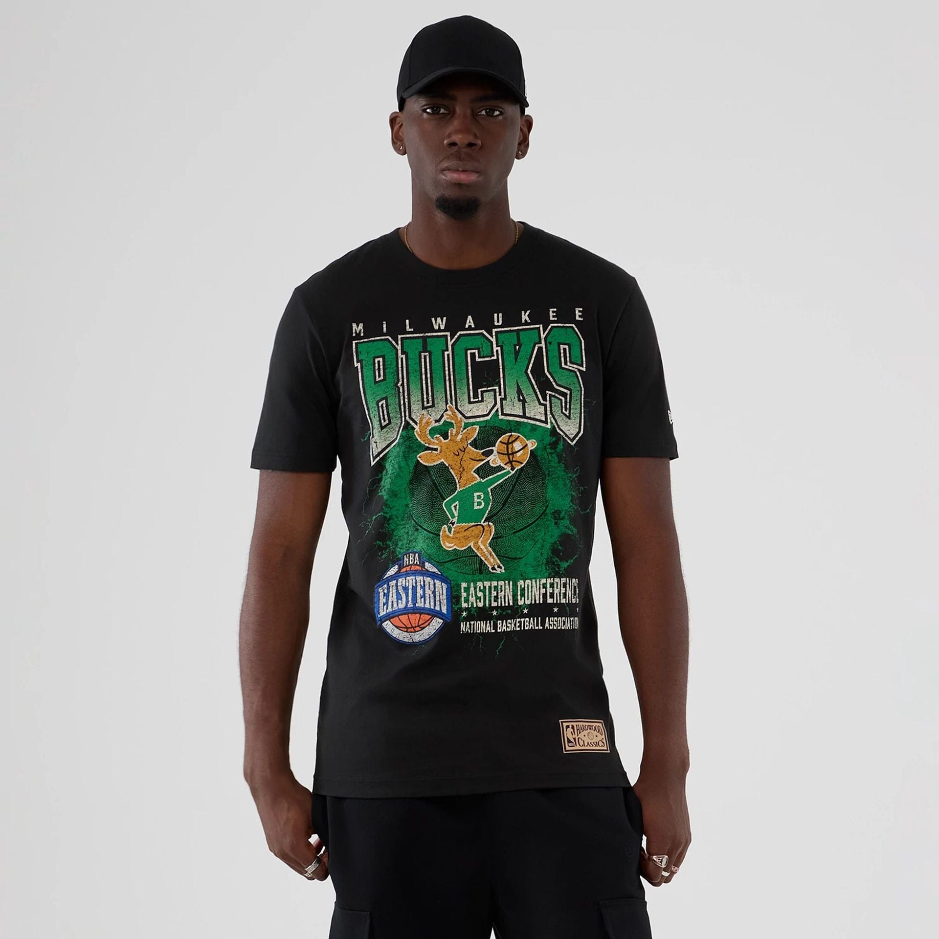 The model is wearing this NBA Hardwood Classic Milwaukee Bucks T-Shirt in black. 1