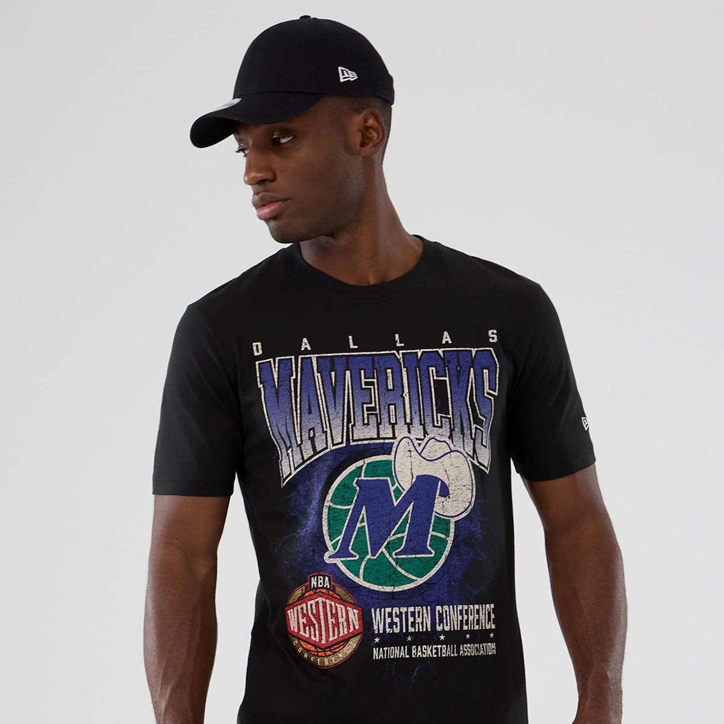 New Era Dallas Mavericks NBA Hardwood Classic Black T-Shirt, front view on-model displaying a Mavericks graphic with a blue and green basketball and cowboy hat, Western Conference logo on the lower front.