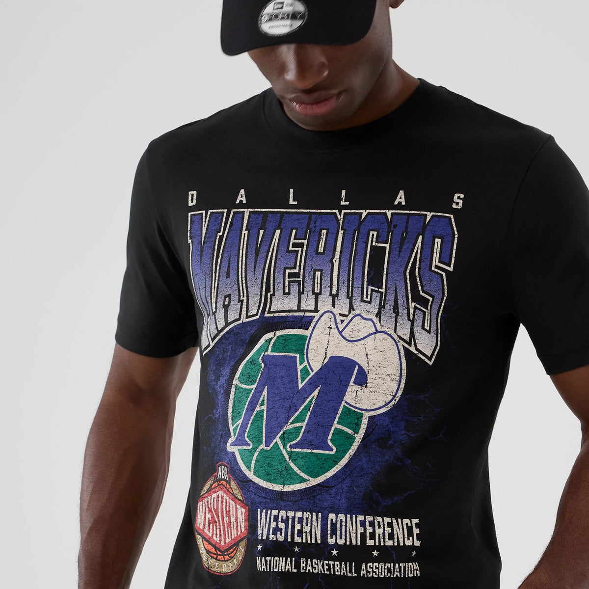 New Era Dallas Mavericks NBA Hardwood Classic Black T-Shirt, front view on-model displaying a large Mavericks graphic with a cowboy hat and team logo in blue and green, lettering across the chest, and Western Conference text at the bottom.