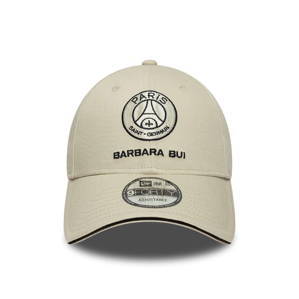 Barbara Bui x Paris Saint-Germain Light Beige New Era 9FORTY Adjustable Cap, front view showing the black embroidered Paris Saint-Germain logo and Barbara Bui text on the crown, with a 9FORTY size sticker on the curved light beige visor.