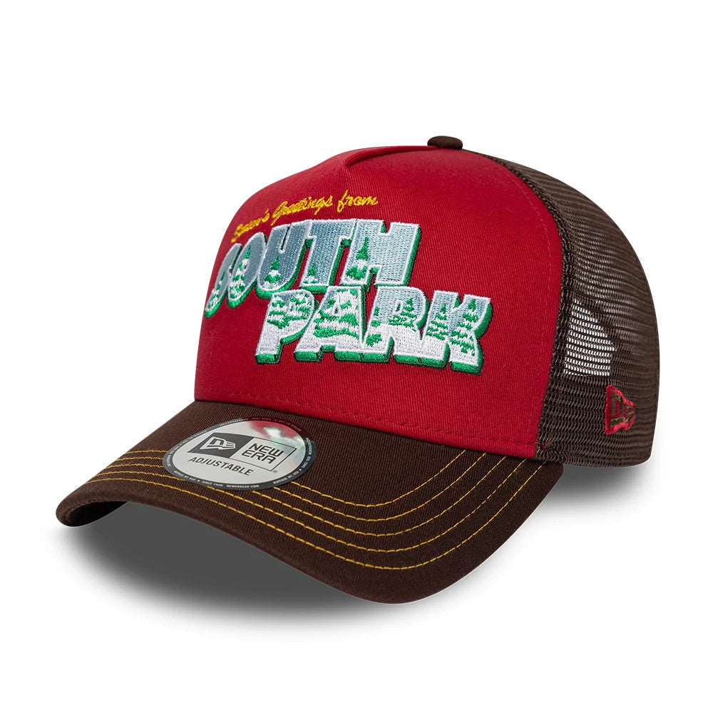 South Park Dark Red New Era 9FORTY A-Frame Trucker Adjustable Cap, three-quarter view showing raised embroidered South Park logo in white and green on red front panel, brown visor with a 9FORTY size sticker, and brown mesh sides.