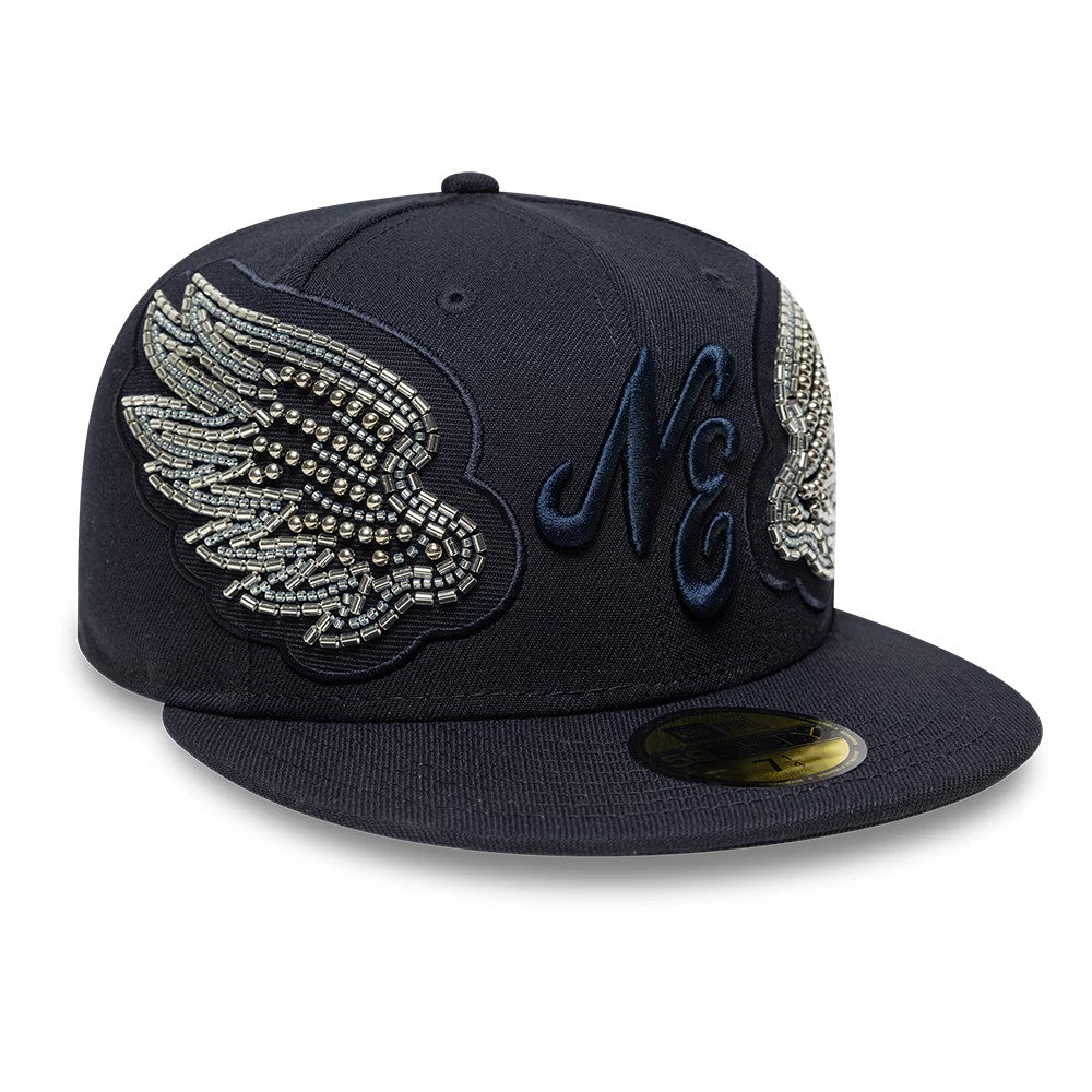 New Era Beaded Wings Navy 59FIFTY Fitted Cap, front view showing intricately beaded silver wings on the navy crown, with a raised embroidered NE logo on the front panel and a gold 59FIFTY size sticker on the flat visor.