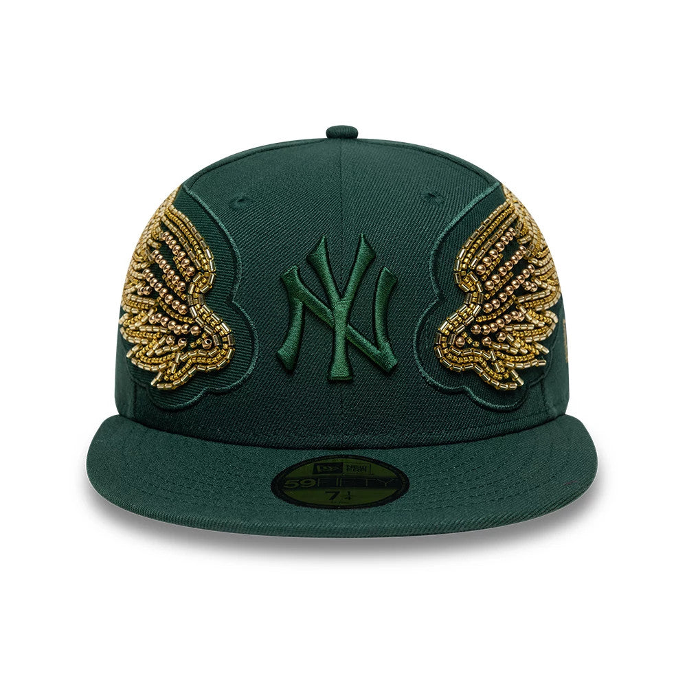 New York Yankees MLB Beaded Wings Dark Green New Era 59FIFTY Fitted Cap, front view showing green raised embroidered NY logo on front panel, intricate gold beaded wing designs on sides, and gold 59FIFTY size sticker on flat dark green visor.