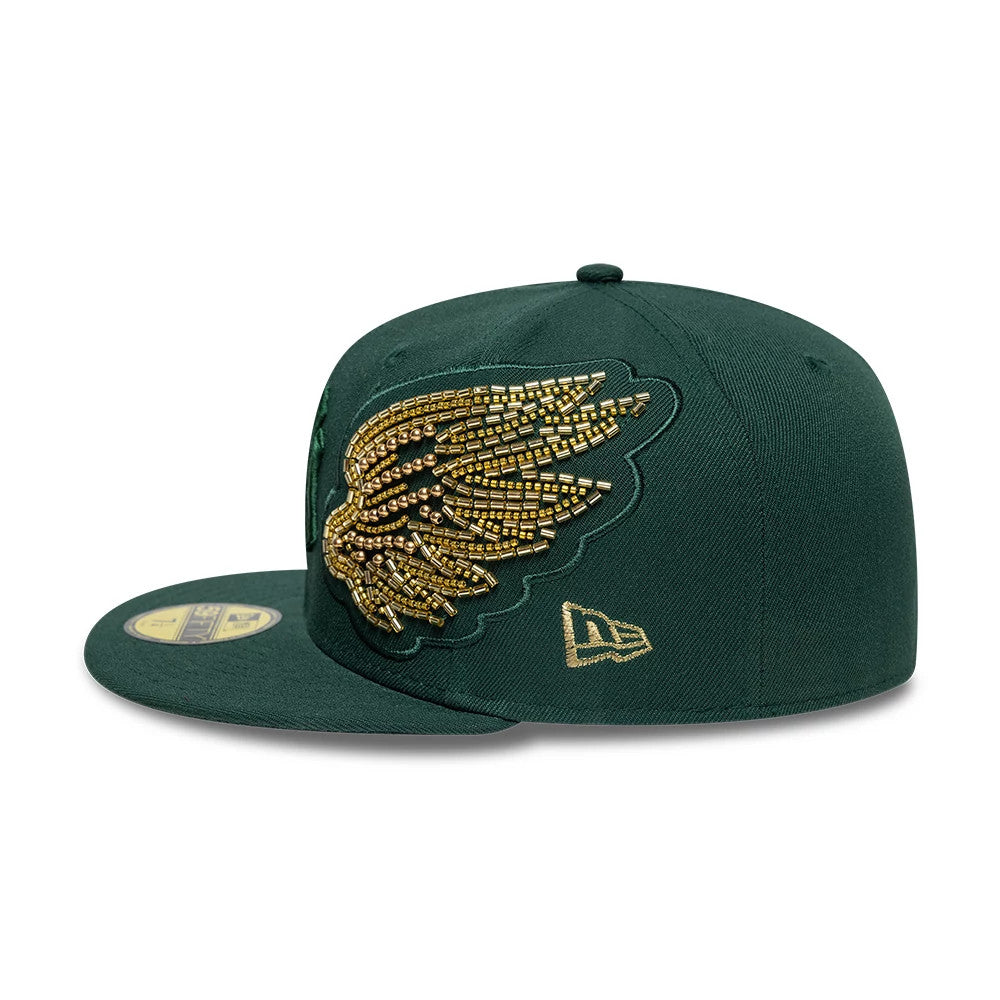 New York Yankees MLB Beaded Wings Dark Green New Era 59FIFTY Fitted Cap, side view showing intricate gold beaded wing design on the dark green crown, with the gold New Era flag logo on the left side.