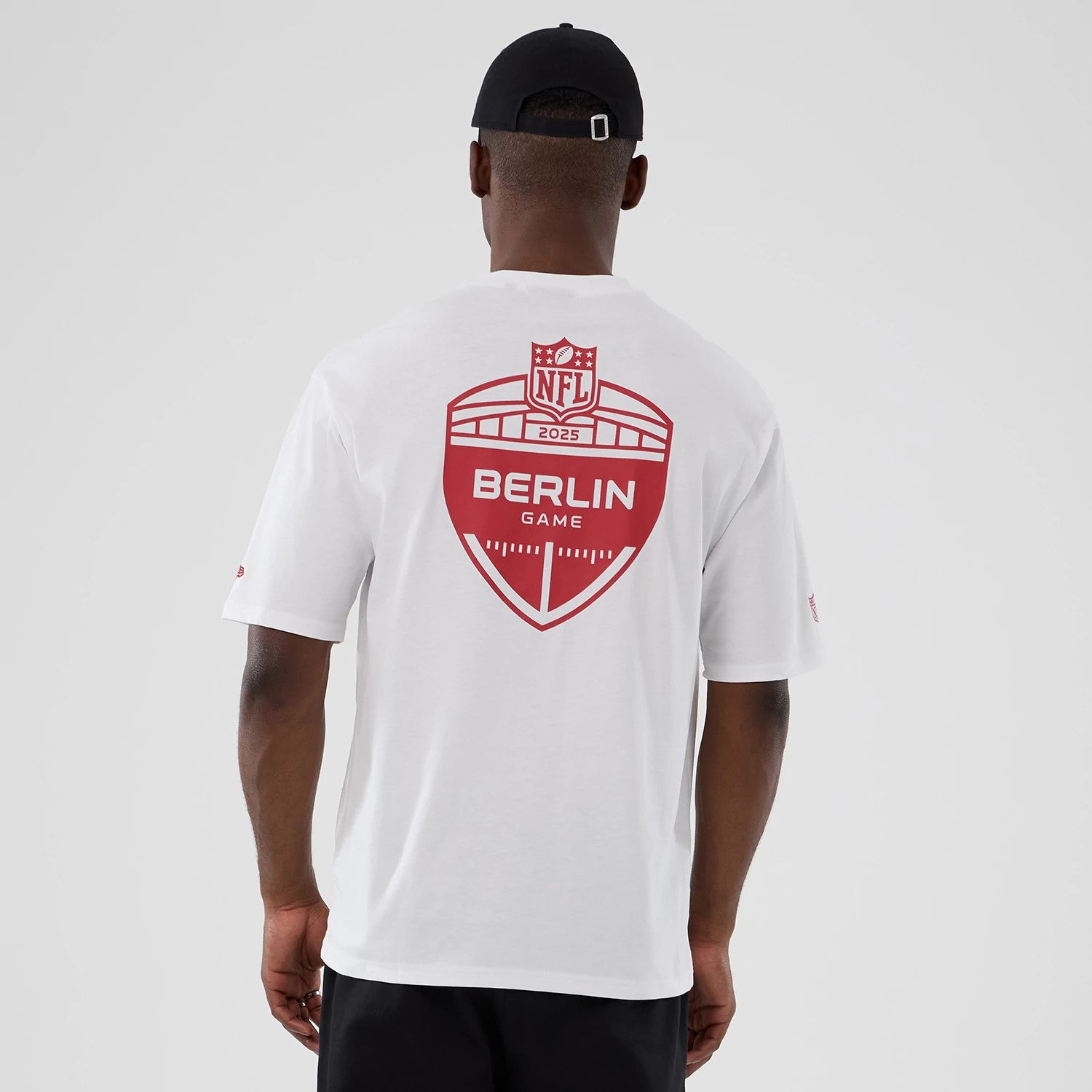 The Male model is wearing Atlanta Falcons NFL International Series Games 2025 White Oversized T-Shirt 2