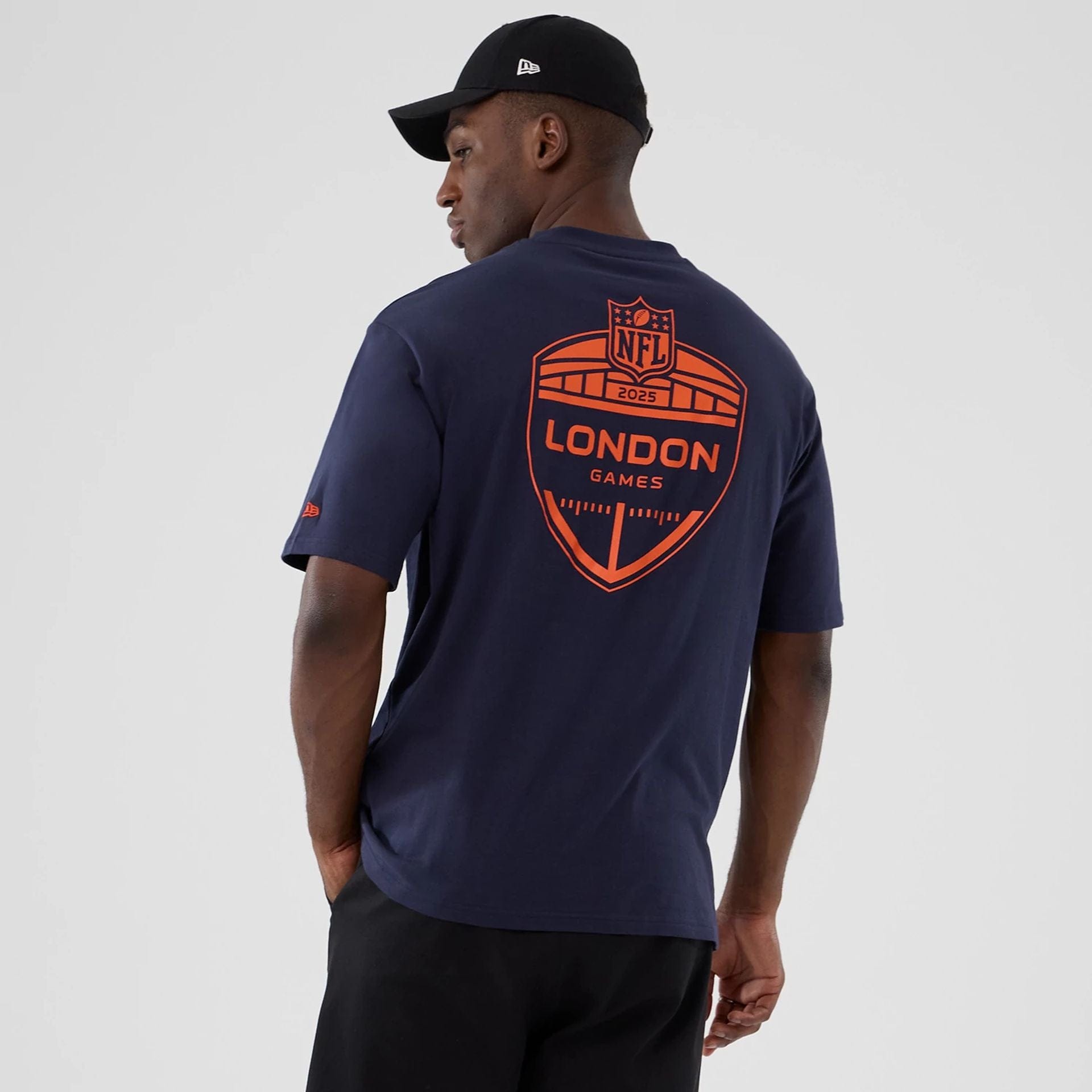 The Male model is wearing Denver Broncos NFL International Series Games 2025 Navy Oversized T-Shirt 2