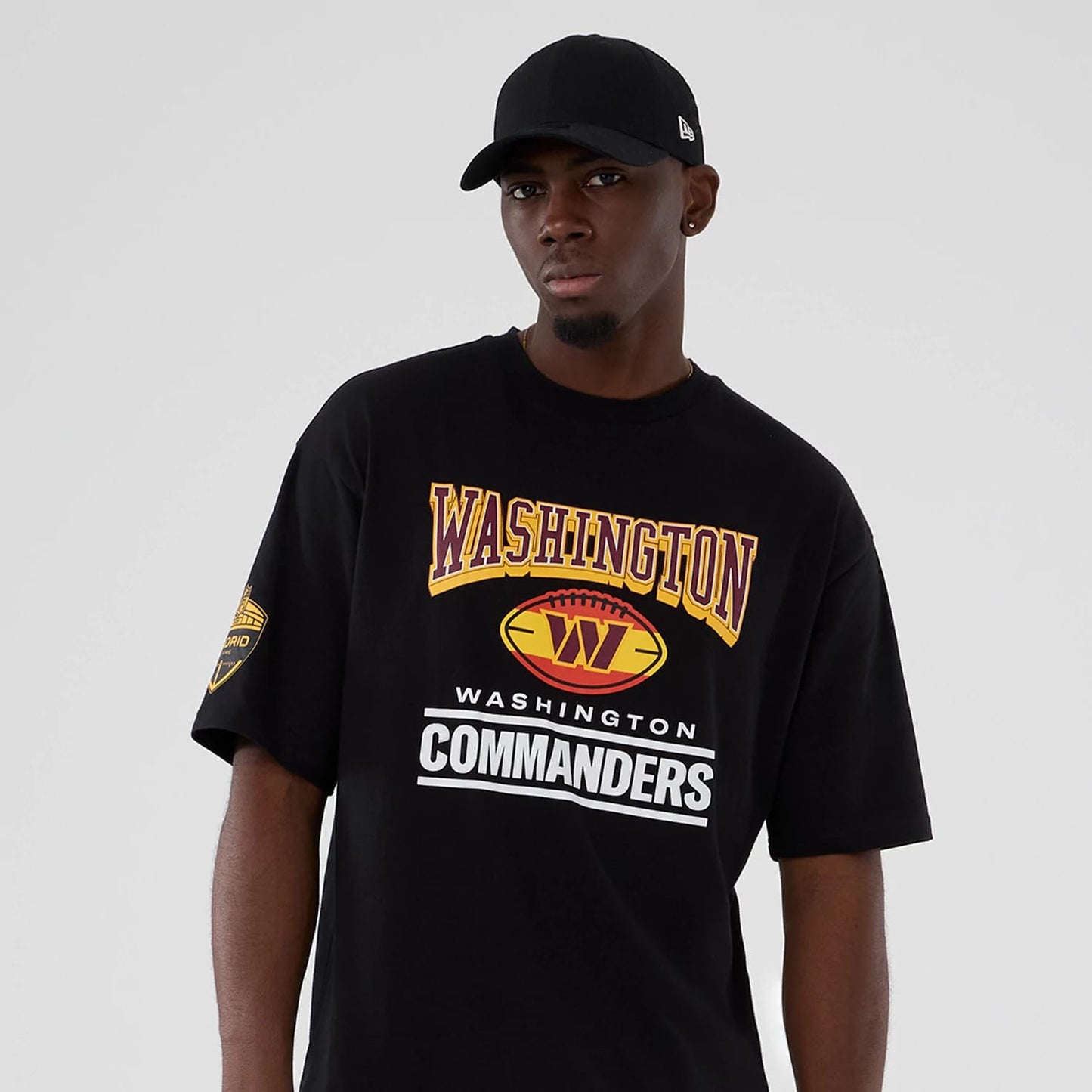 The Male model is wearing Washington Commanders Script NFL International Series Games 2025 Black Oversized T-Shirt 7