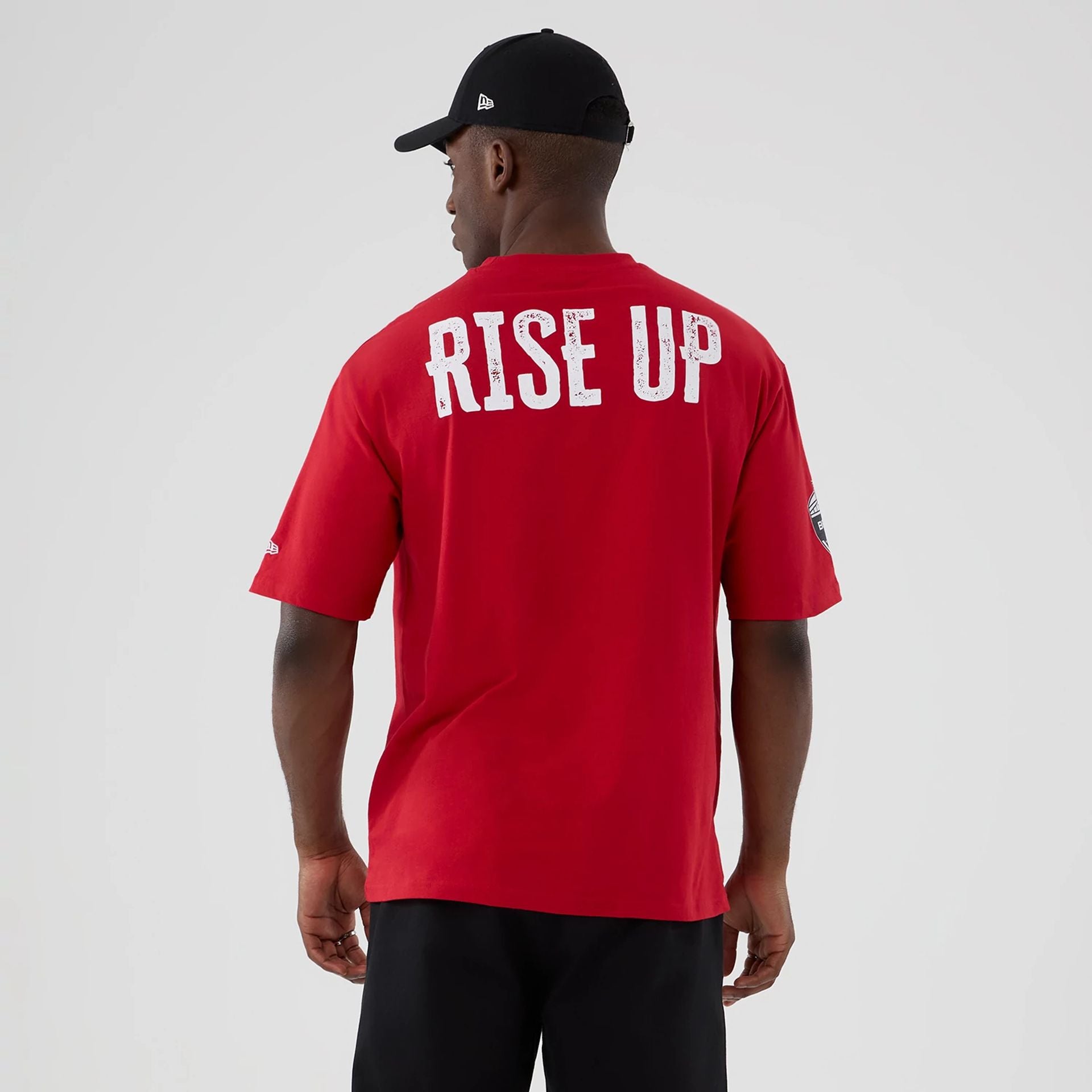 The Male model is wearing Atlanta Falcons NFL International Series Games 2025 Red Oversized T-Shirt 2