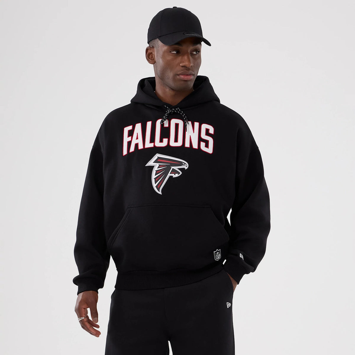 New Era Atlanta Falcons NFL International Series Games 2025 Black Premium Pullover Hoodie, front view featuring raised Falcons lettering and logo on the chest and a small embroidered New Era logo on the cuff.