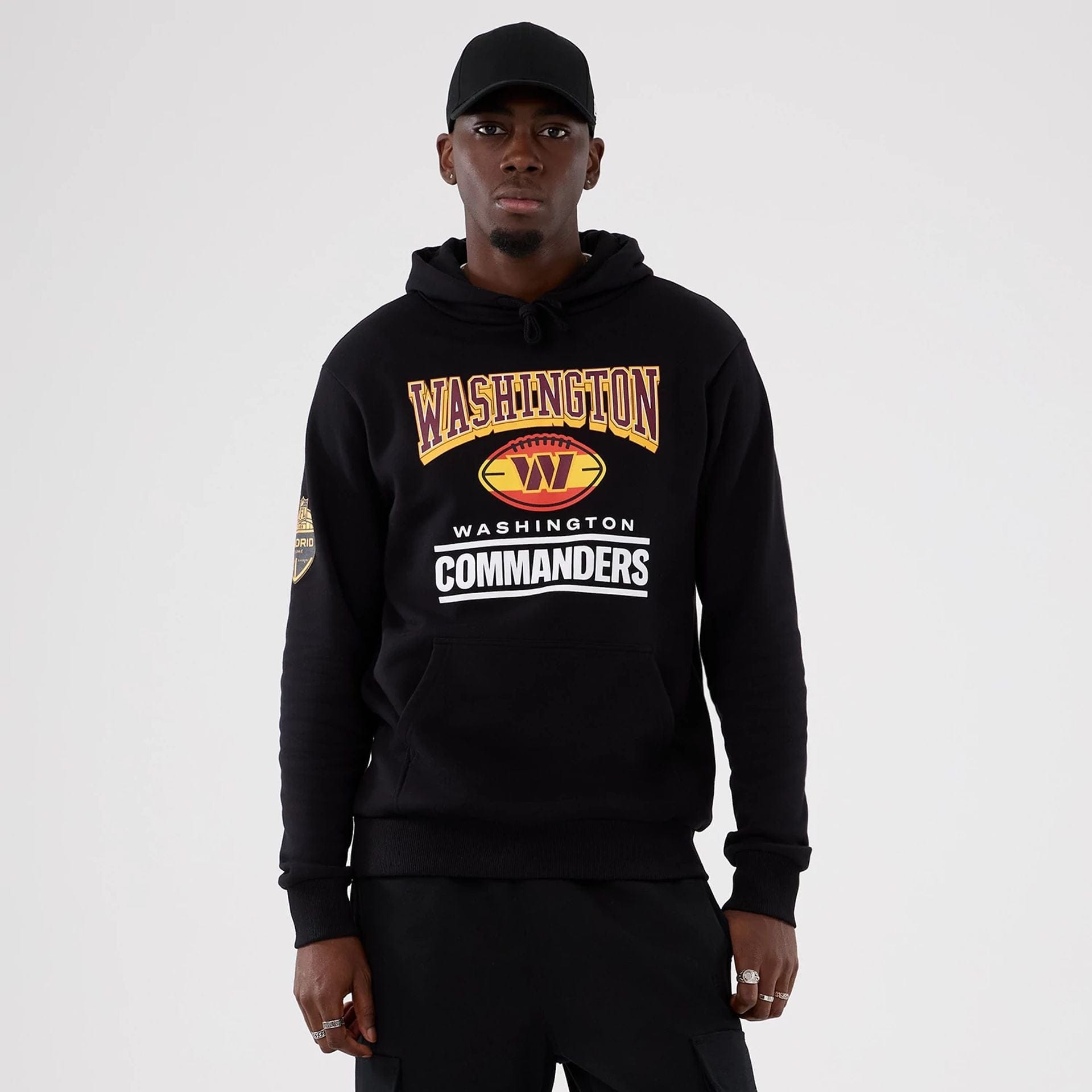 The Male model is wearing Washington Commanders NFL International Series Games 2025 Black Pullover Hoodie 1