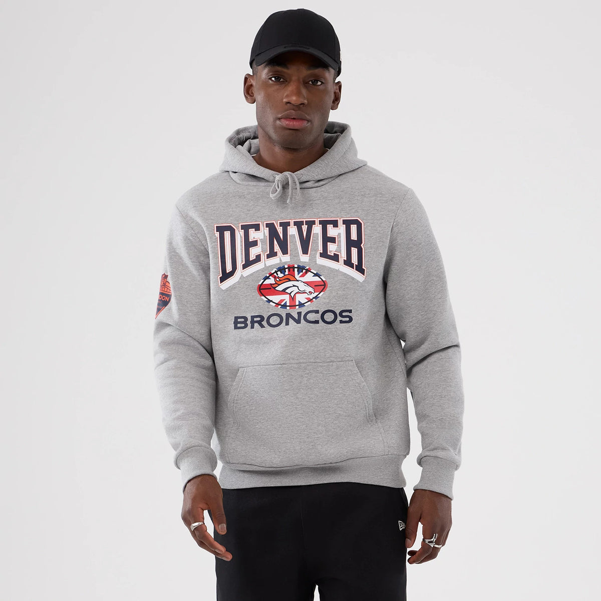 The Male model is wearing Denver Broncos NFL International Series Games 2025 Grey Pullover Hoodie 1