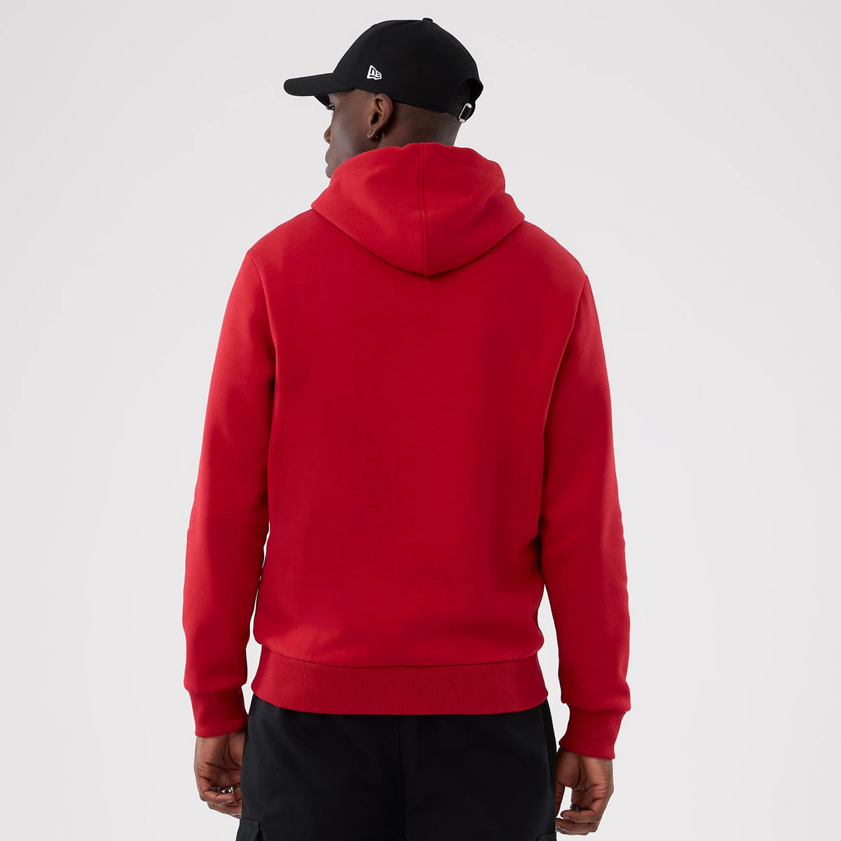New Era Atlanta Falcons NFL International Series Games 2025 Red Pullover Hoodie, back view on-model showing the plain red back with a relaxed fit and the hood resting on the upper shoulders.
