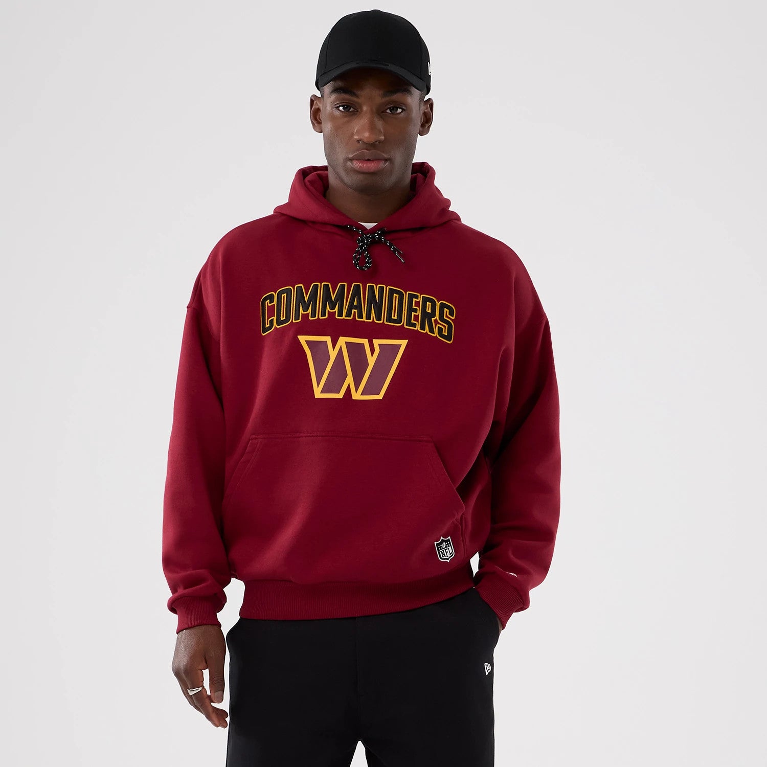 The Male model is wearing Washington Commanders NFL International Series Games 2025 Dark Red Premium Pullover Hoodie 1