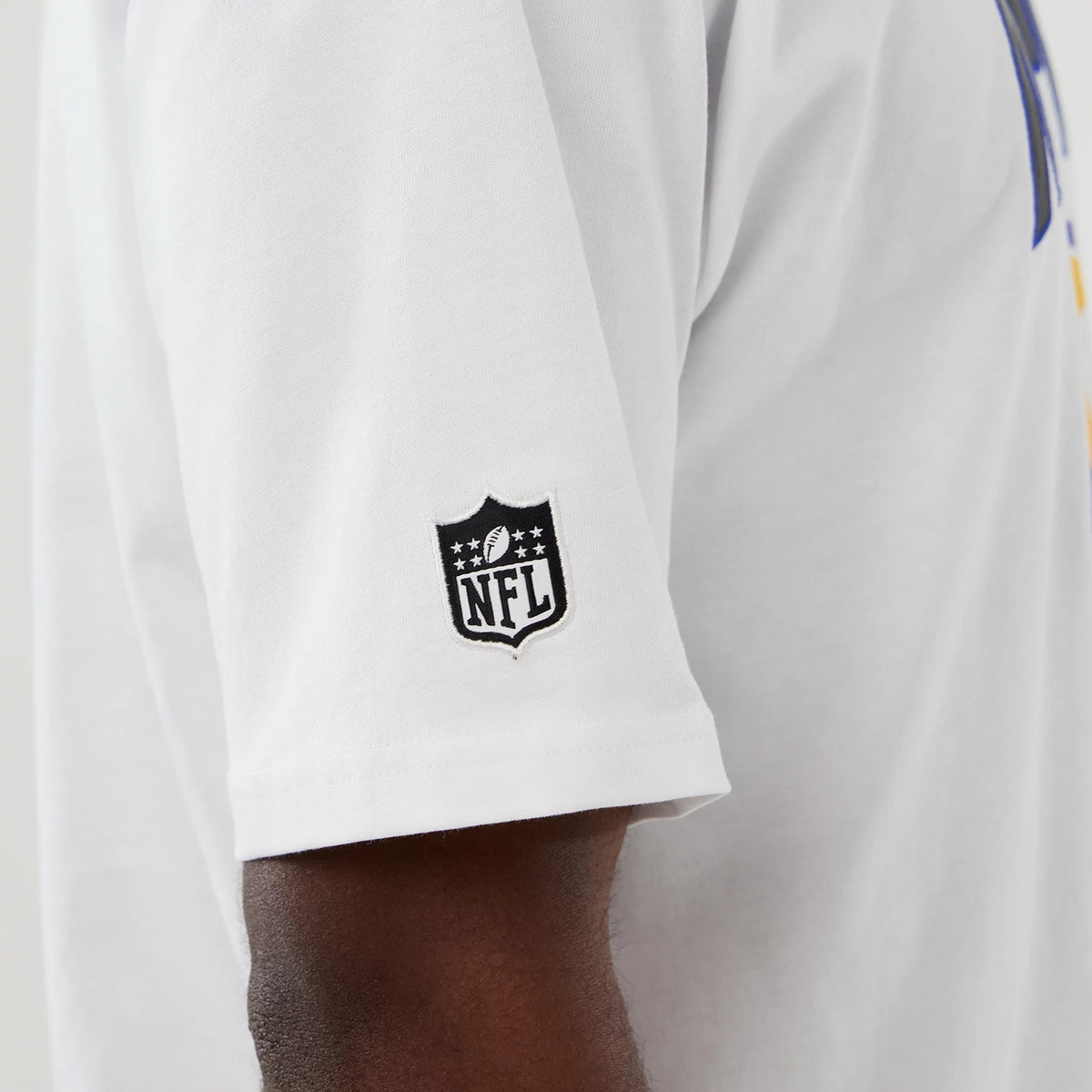 New Era LA Rams NFL International Series Games 2025 White Premium T-Shirt, side view showing a white sleeve with an embroidered black NFL logo, the rest of the shirt partly in crisp white fabric.