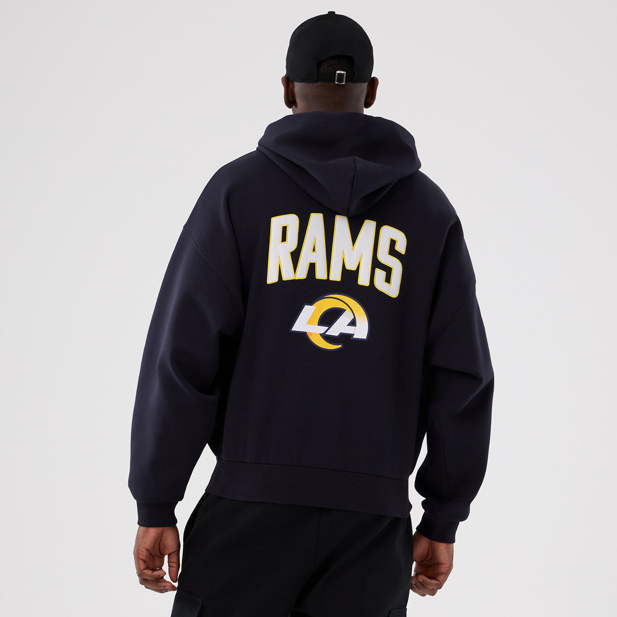The Male model is wearing LA Rams NFL International Series Games 2025 Navy Premium Pullover Hoodie 2